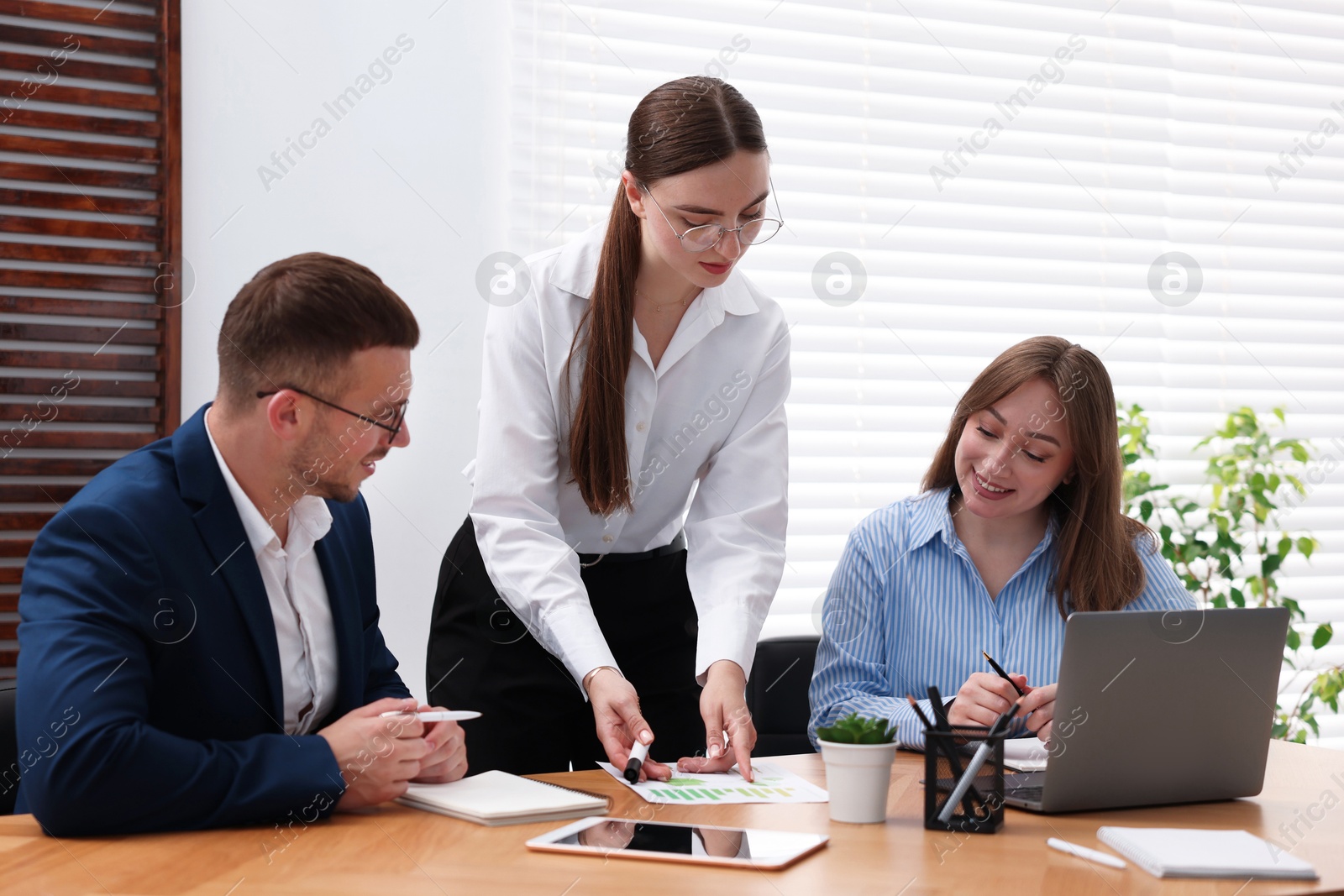 Business coach working with group of people in office Photo of Business coach working with group of people in office