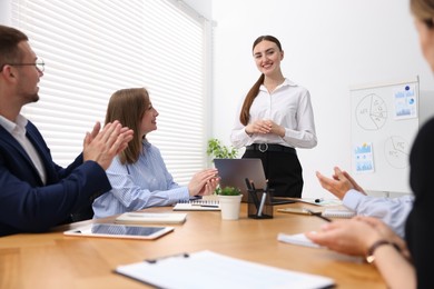 Photo of Business coach giving presentation to group of people in office