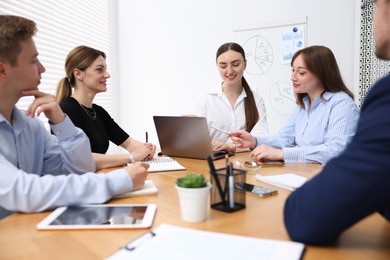 Photo of Business coach giving presentation to group of people in office