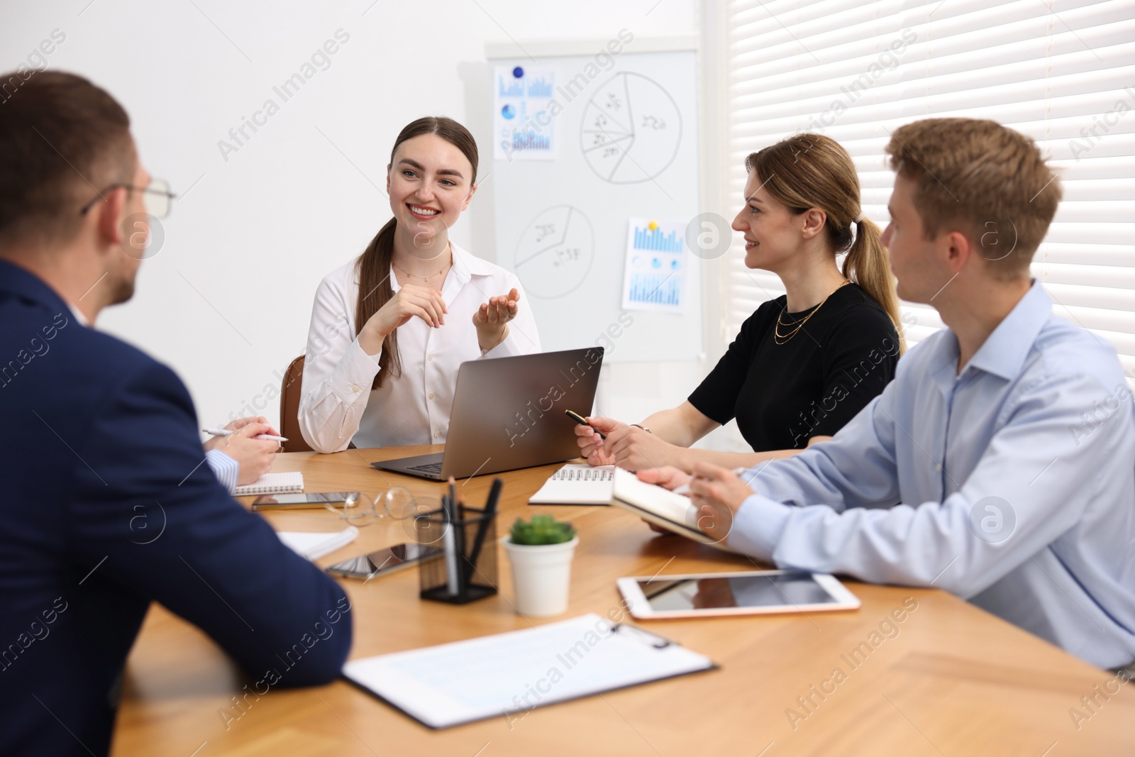 Business coach giving presentation to group of people in office Photo of Business coach giving presentation to group of people in office