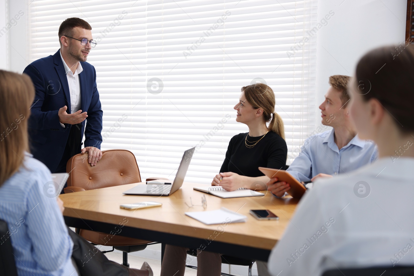 Business coach working with group of people in office Photo of Business coach working with group of people in office