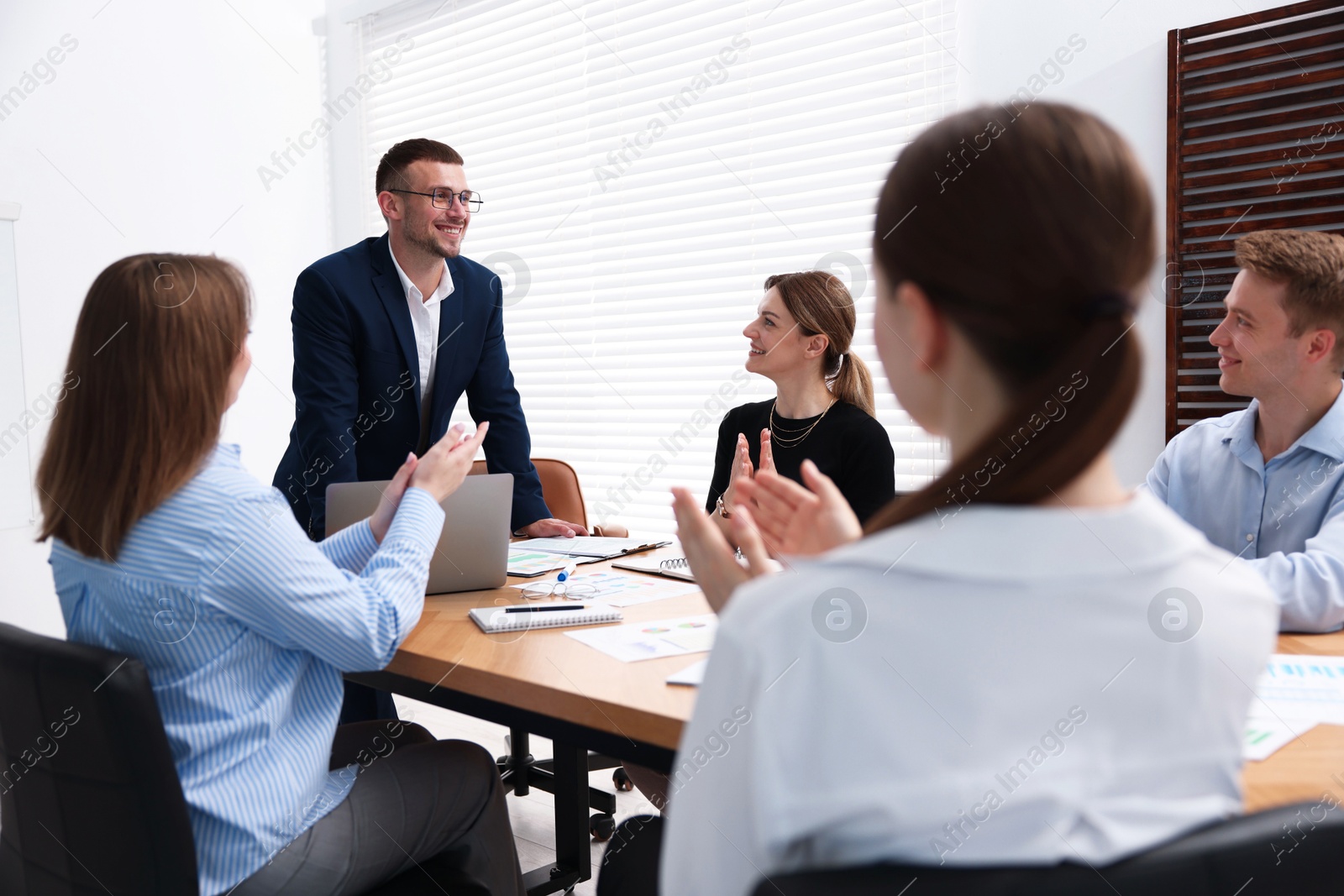 Business coach working with group of people in office Photo of Business coach working with group of people in office