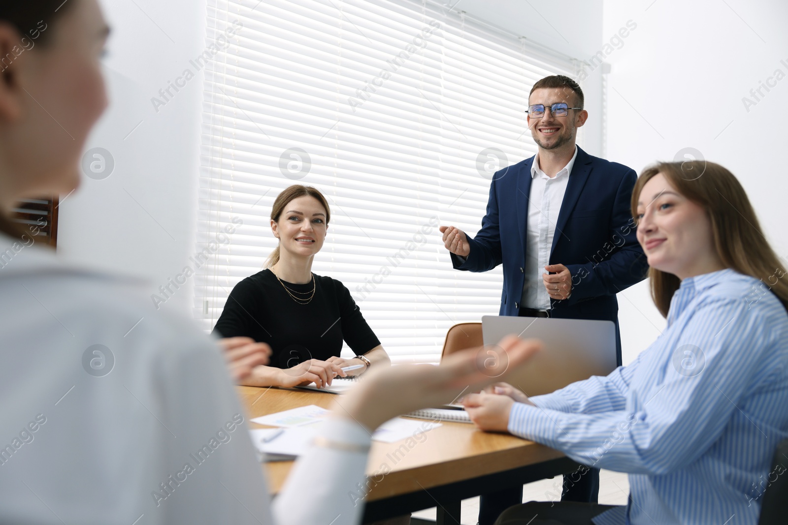 Business coach giving presentation to group of people in office Photo of Business coach giving presentation to group of people in office