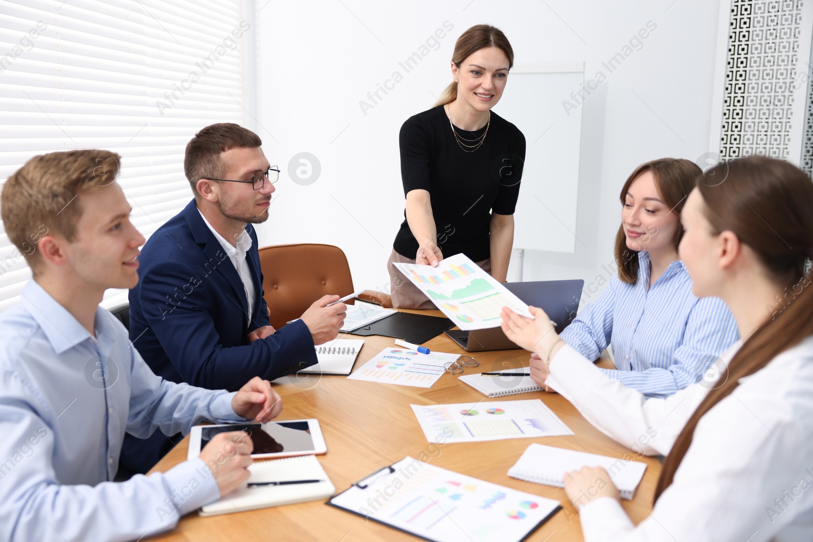 Business coach giving presentation to group of people in office Photo of Business coach giving presentation to group of people in office