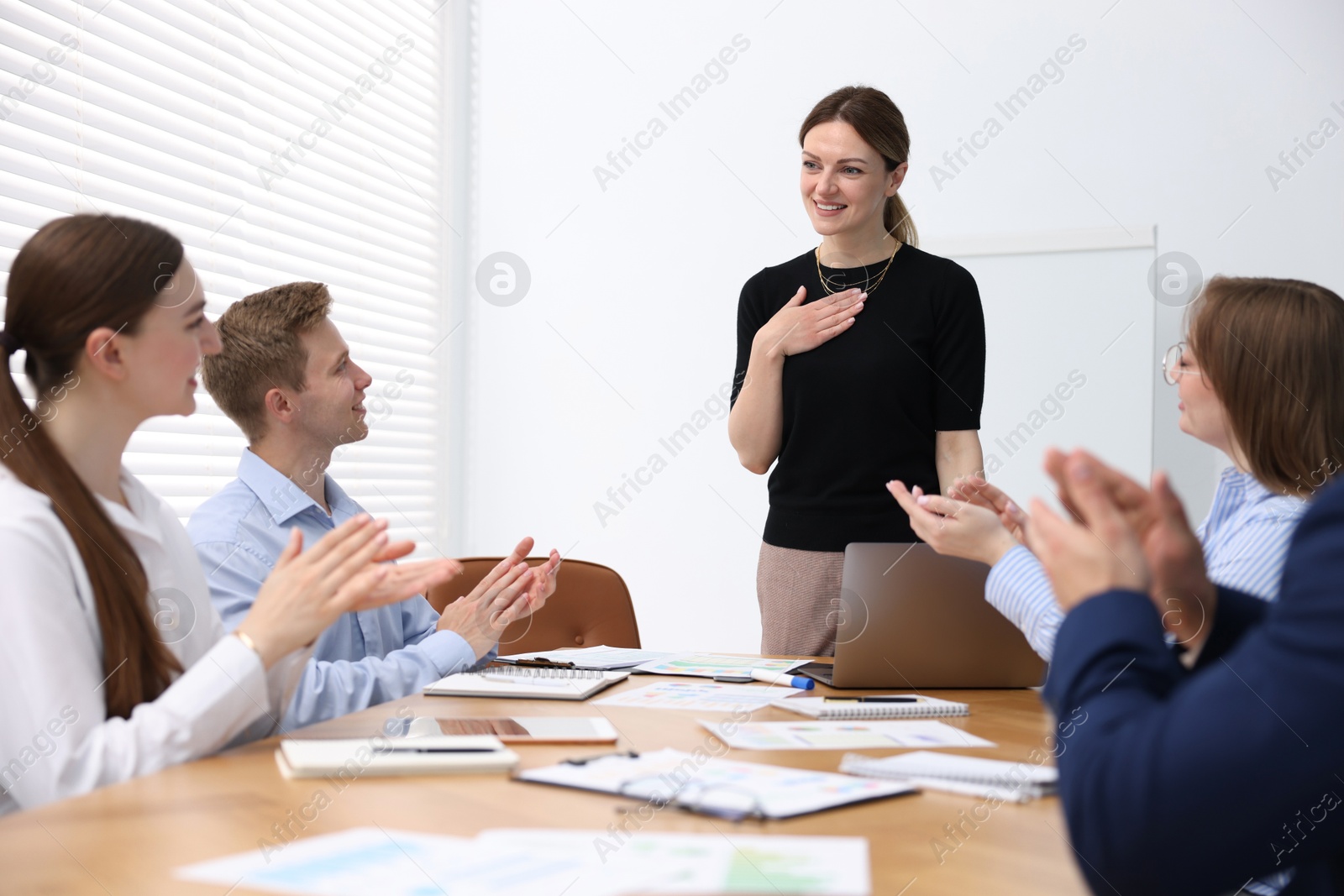 Business coach giving presentation to group of people in office Photo of Business coach giving presentation to group of people in office