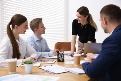 Photo of Business coach giving presentation to group of people in office