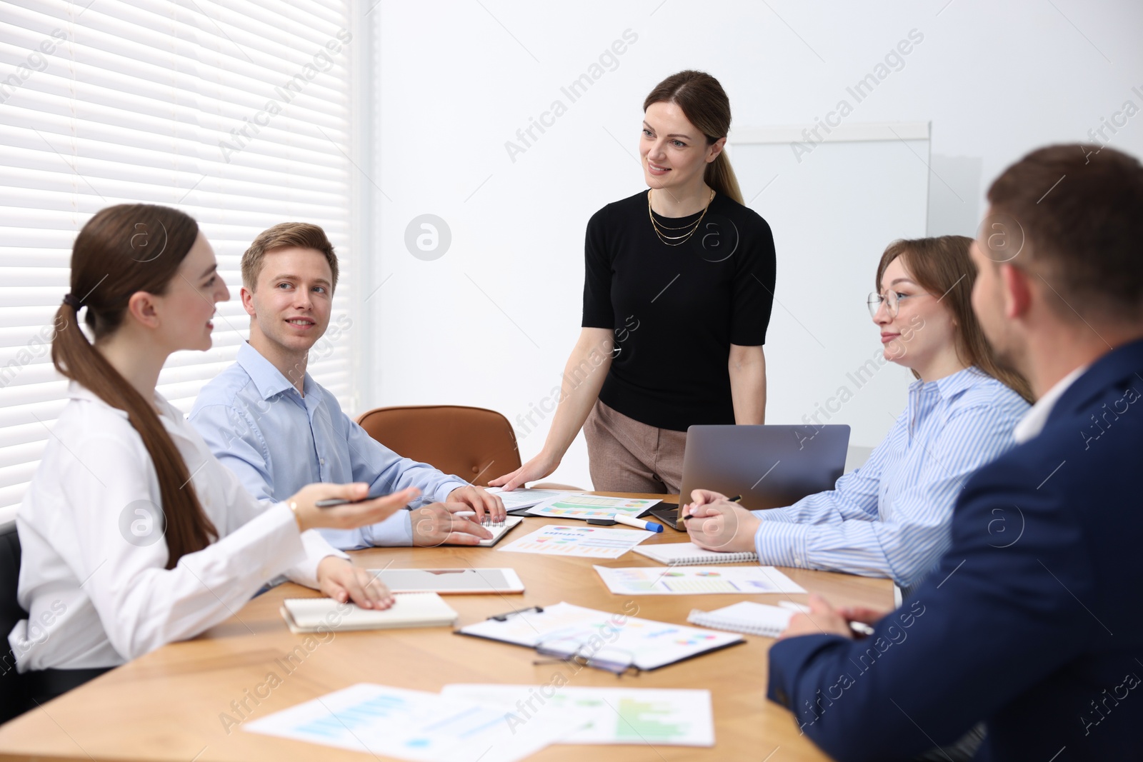 Business coach giving presentation to group of people in office Photo of Business coach giving presentation to group of people in office