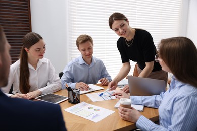 Photo of Business coach giving presentation to group of people in office