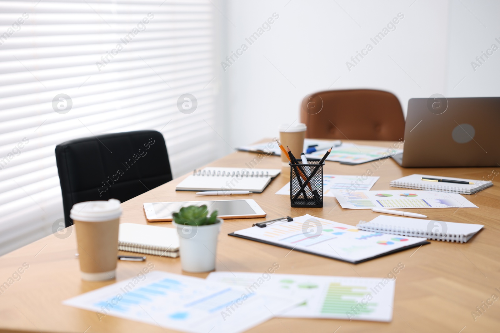 Stylish workplace with stationery and laptop in office, selective focus Photo of Stylish workplace with stationery and laptop in office, selective focus