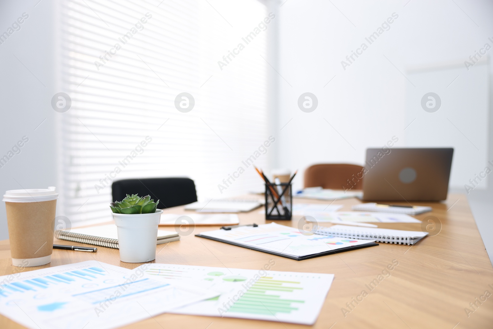 Stylish workplace with stationery and laptop in office, selective focus Photo of Stylish workplace with stationery and laptop in office, selective focus