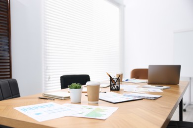 Photo of Stylish workplace with stationery and laptop in office, selective focus