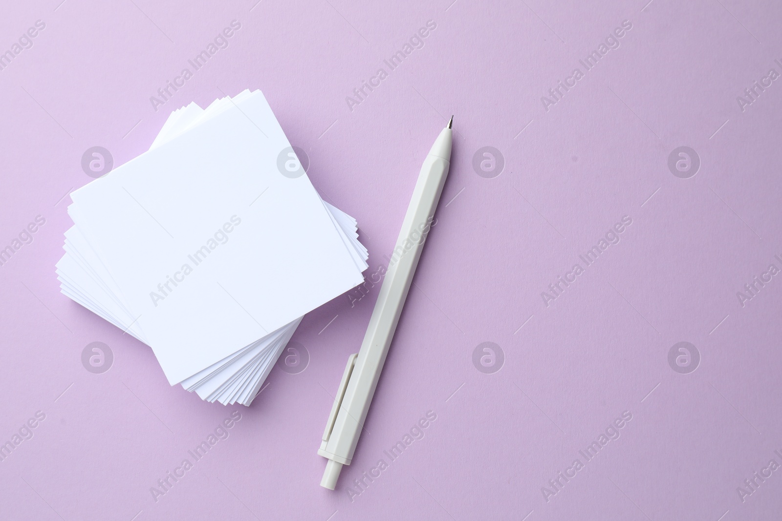 White stationery on violet background, flat lay Photo of White stationery on violet background, flat lay