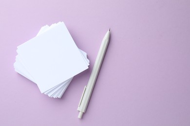 Photo of White stationery on violet background, flat lay