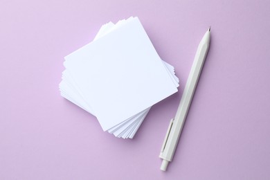 Photo of White stationery on violet background, flat lay