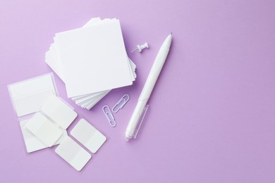 Photo of Different white stationery on violet background, flat lay. Space for text