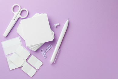 Photo of Different white stationery on violet background, flat lay. Space for text