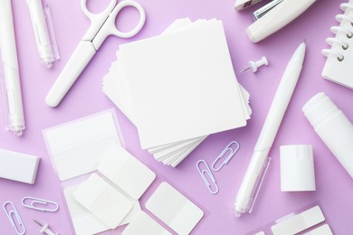Photo of Different white stationery on violet background, flat lay