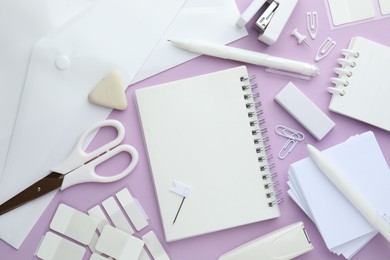 Photo of Different white stationery on violet background, flat lay