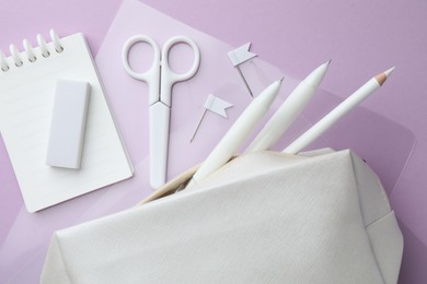 Photo of Different white stationery on violet background, flat lay