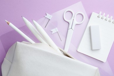 Photo of Different white stationery on violet background, flat lay