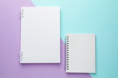 Photo of White notebooks on color background, flat lay