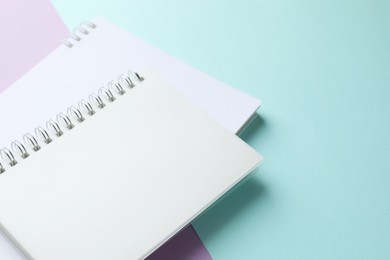 Photo of White notebooks on color background, closeup. Space for text