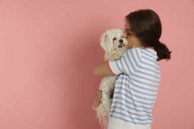 Photo of Happy teenage girl with Maltese dog on pink background, space for text