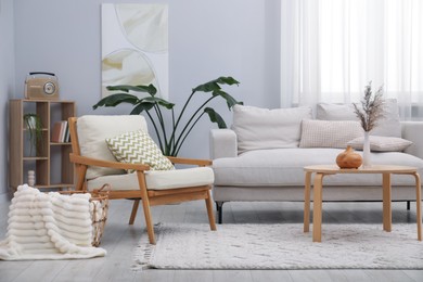 Photo of Comfortable armchairs and other furniture in living room. Interior design