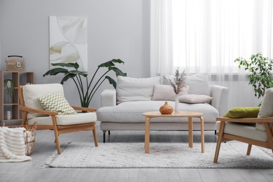Photo of Comfortable armchairs and other furniture in living room. Interior design