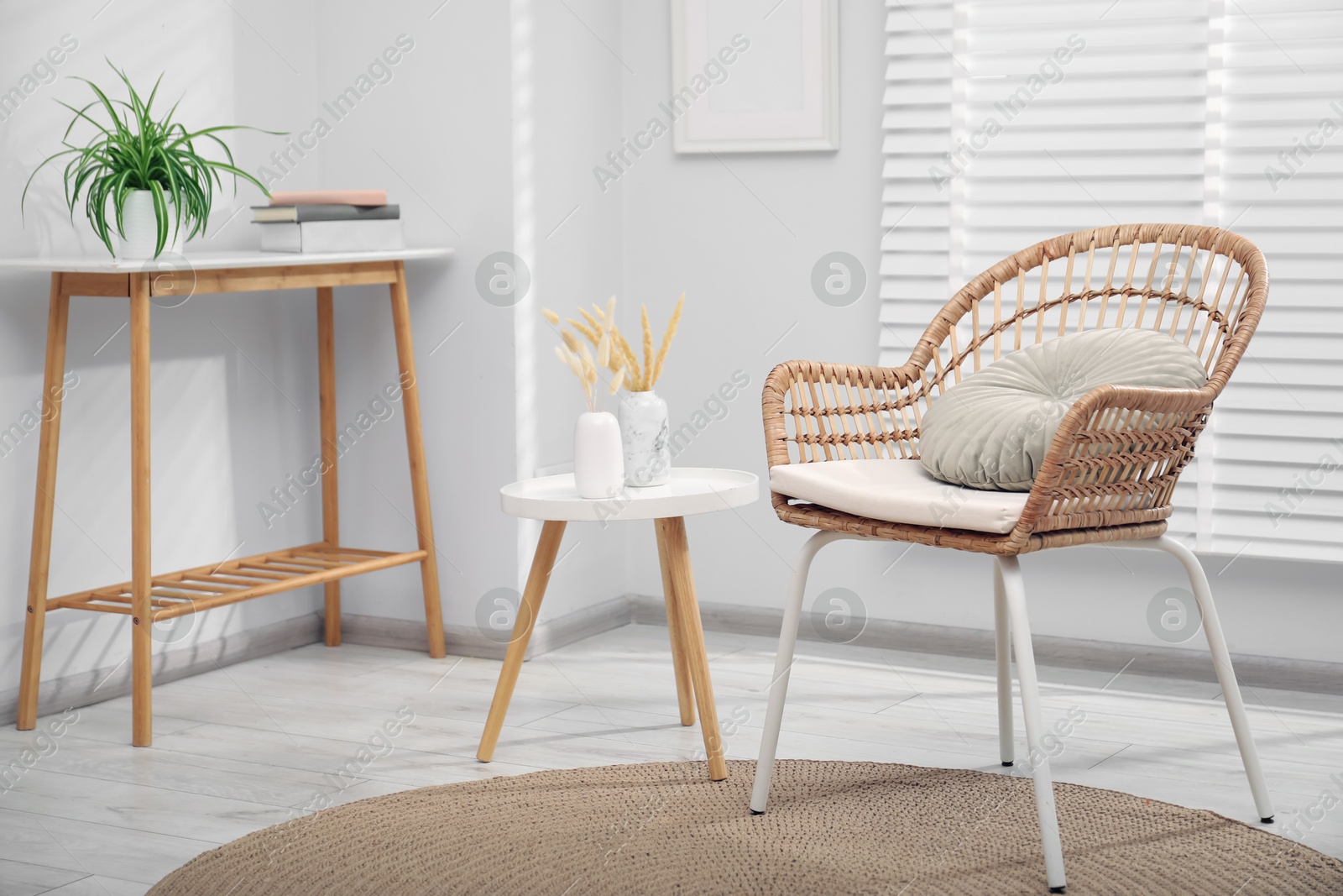 Photo of Comfortable armchair and other furniture in living room. Interior design