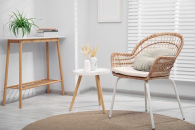 Photo of Comfortable armchair and other furniture in living room. Interior design