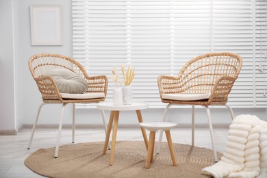 Photo of Comfortable armchairs and tables in living room. Interior design