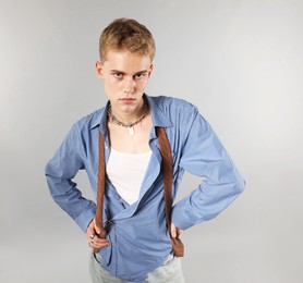 Photo of Handsome young man wearing stylish clothes on light grey background