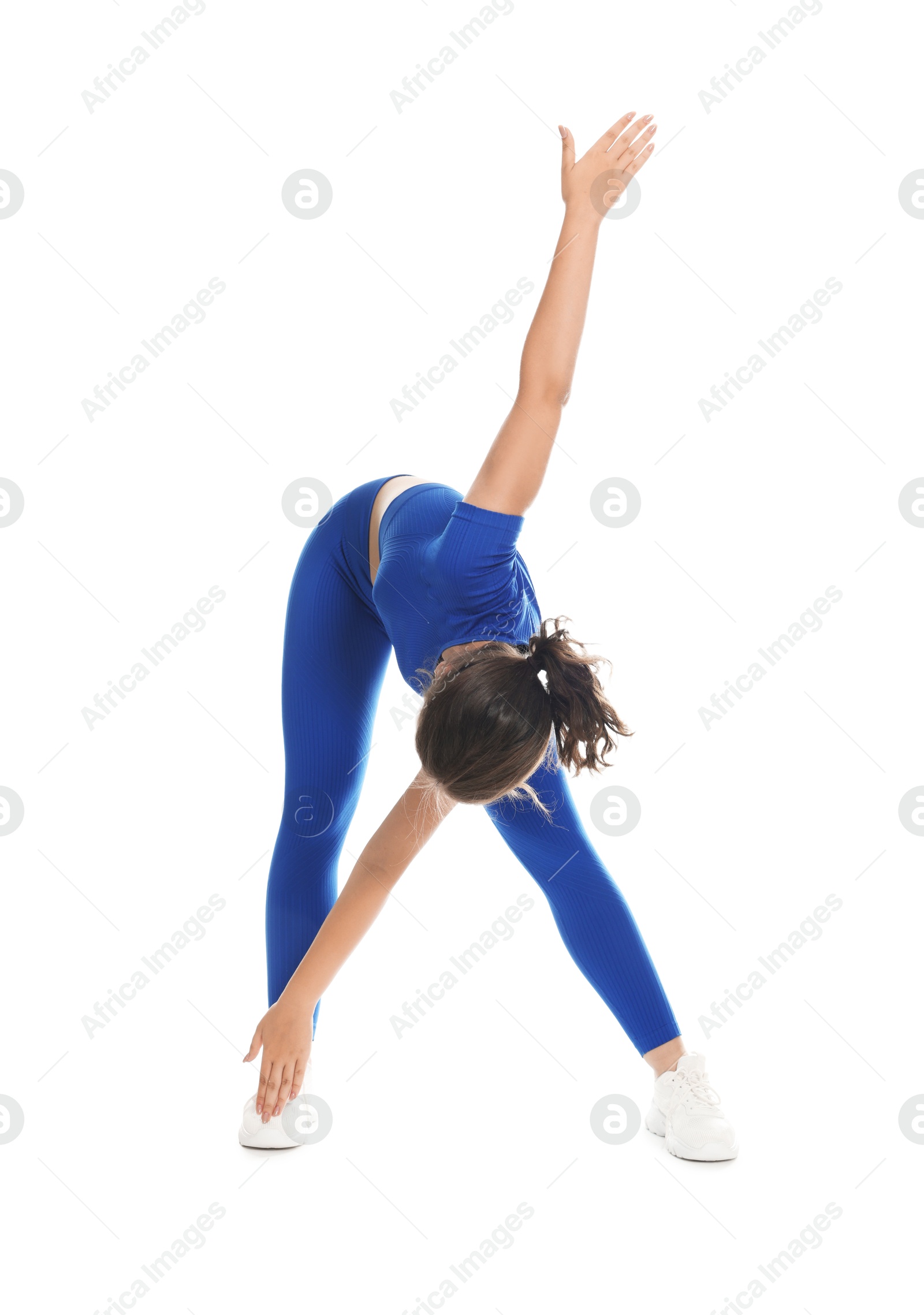 Photo of Teenage girl in sportswear stretching on white background