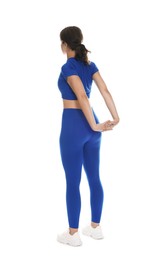 Photo of Teenage girl in sportswear stretching on white background