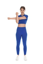 Photo of Teenage girl in sportswear stretching on white background