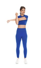 Photo of Teenage girl in sportswear stretching on white background