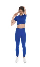 Photo of Teenage girl in sportswear stretching on white background