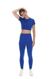 Photo of Teenage girl in sportswear stretching on white background