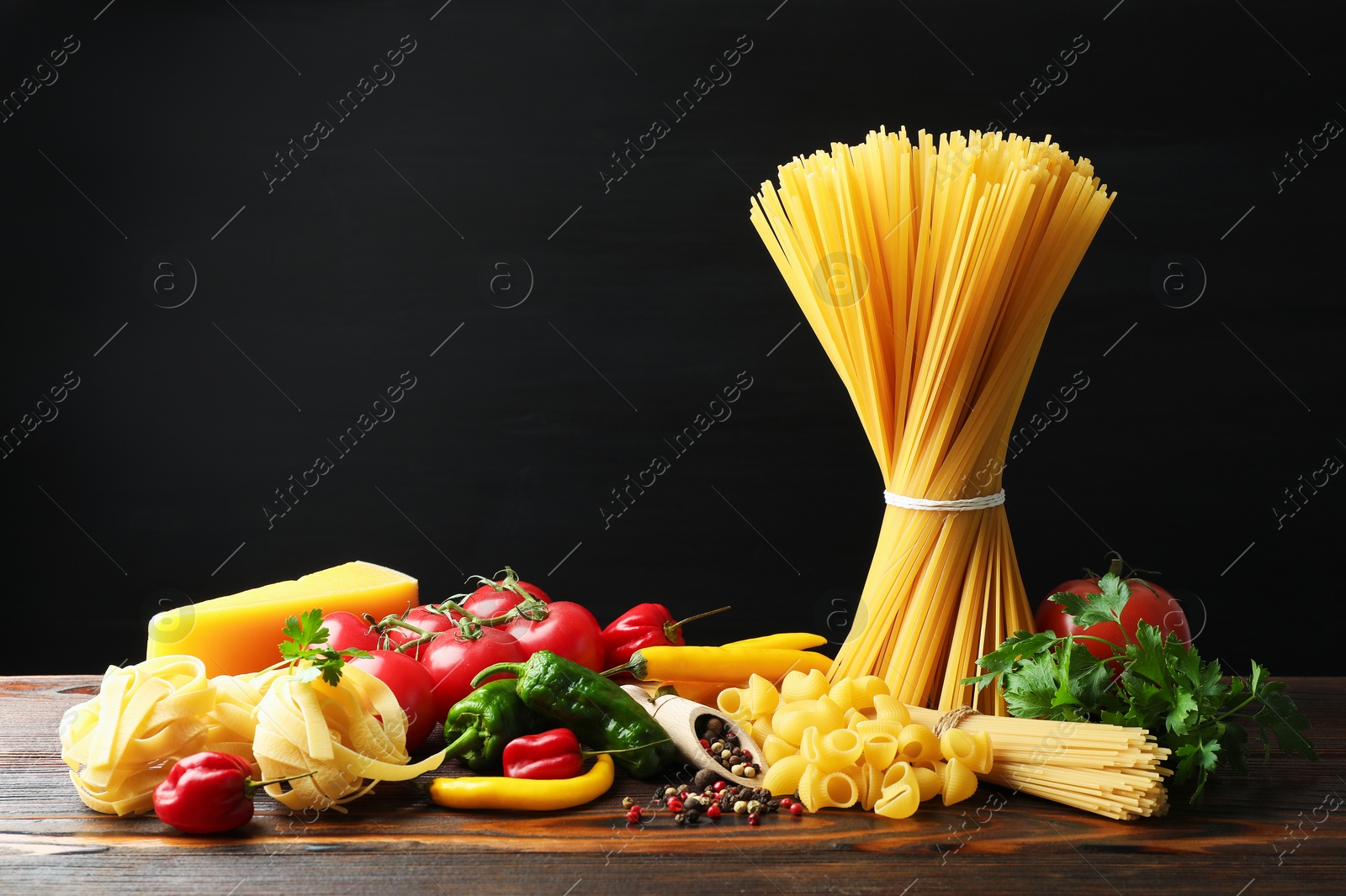 Different types of pasta and ingredients on wooden table Photo of Different types of pasta and ingredients on wooden table