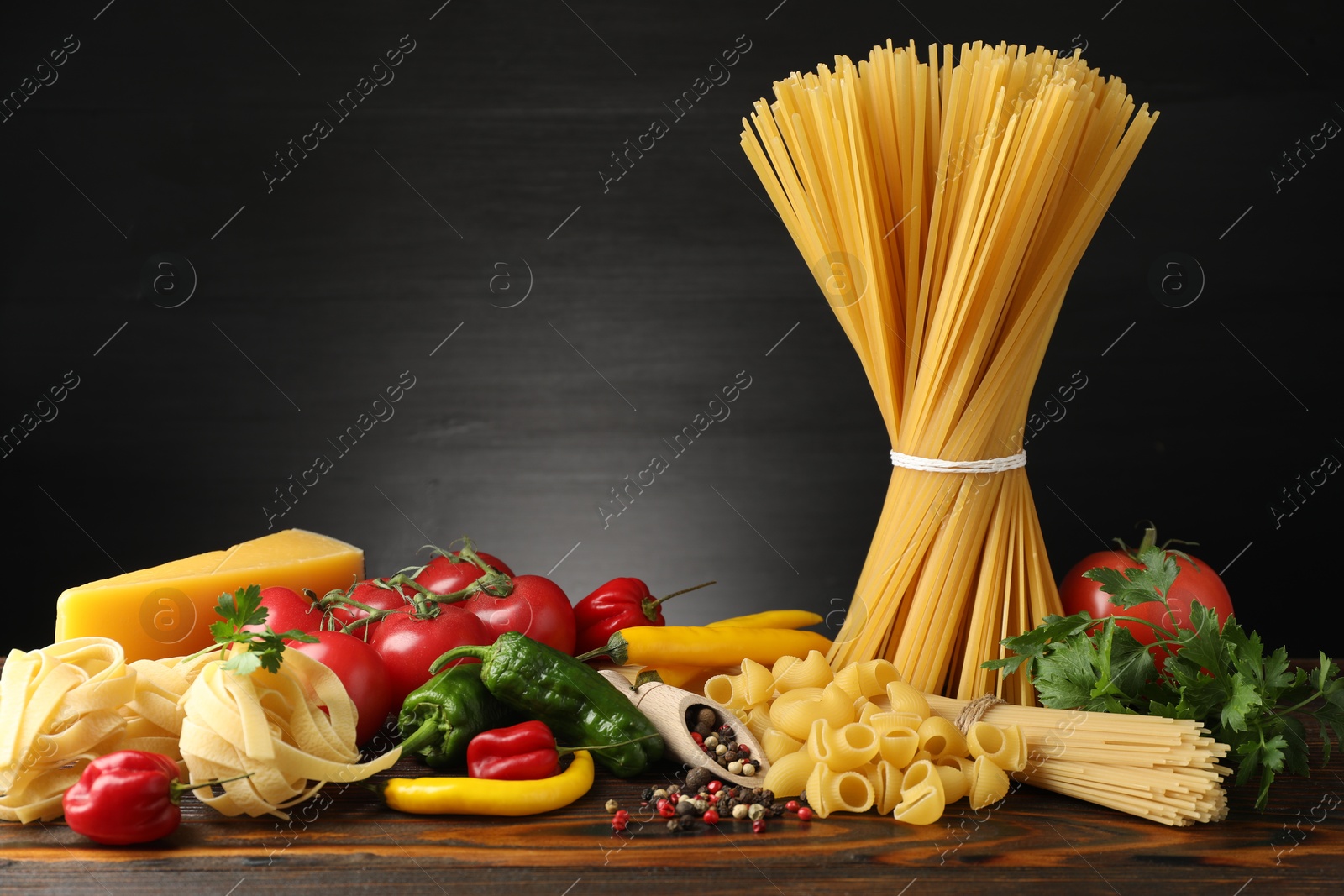 Different types of pasta and ingredients on wooden table Photo of Different types of pasta and ingredients on wooden table