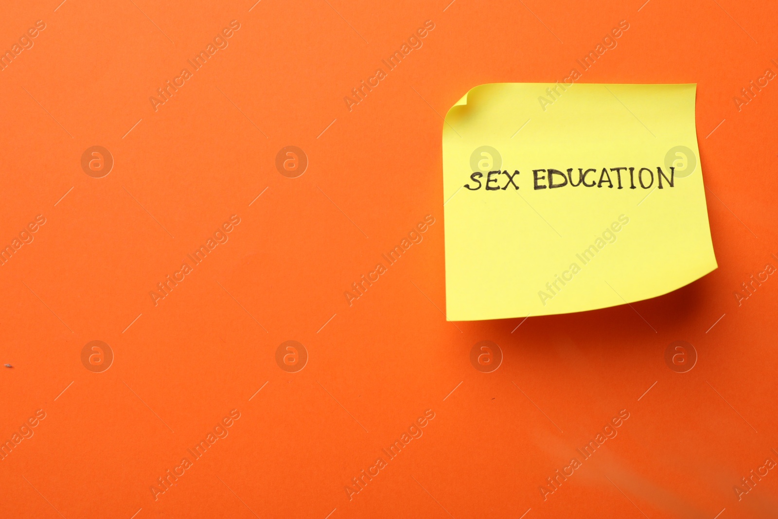 Photo of Sticky note with words Sex Education on orange background, top view. Space for text