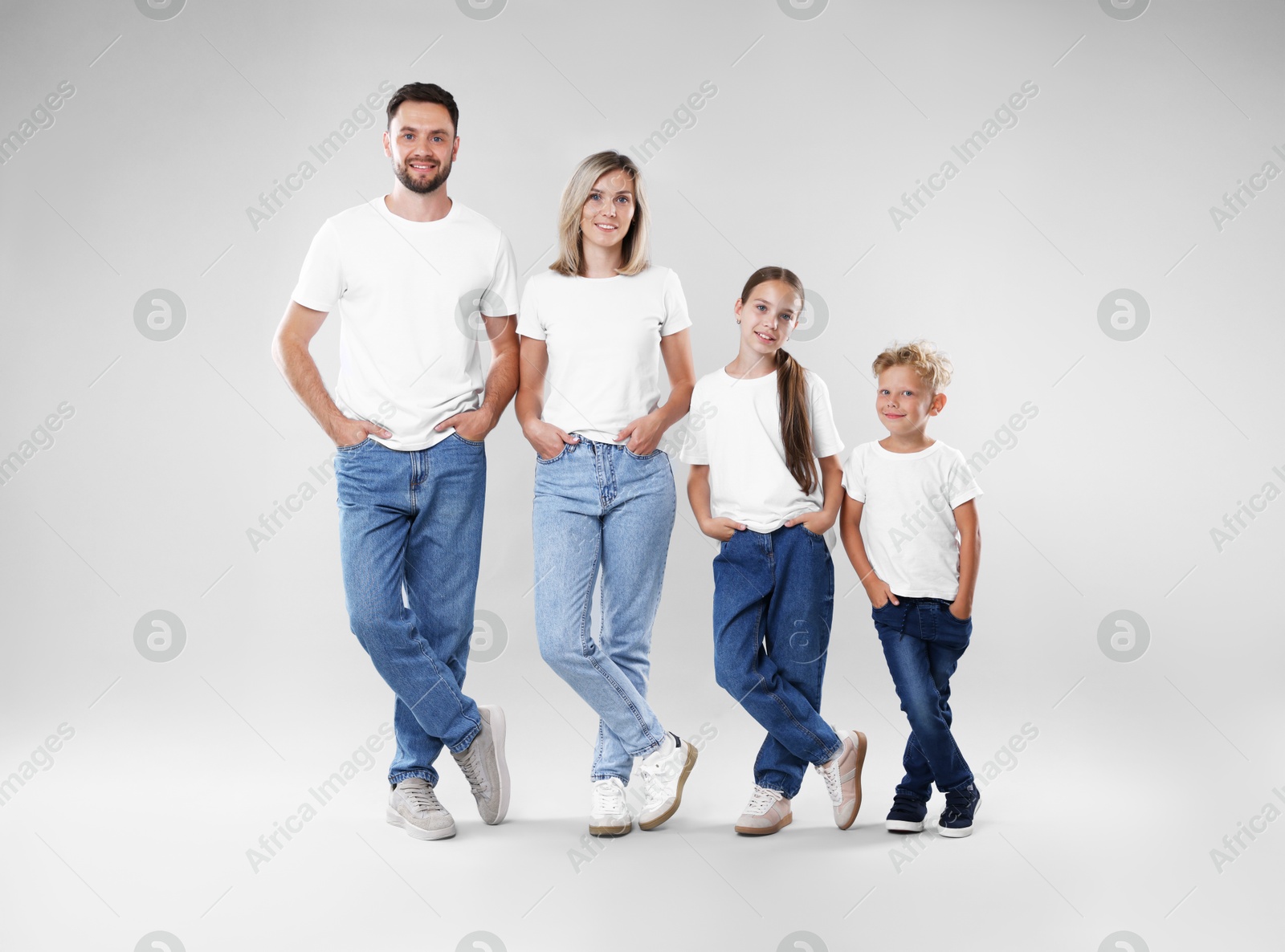 Happy parents and their children posing on grey background. Family Photo of Happy parents and their children posing on grey background. Family