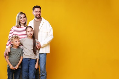 Photo of Happy family on yellow background. Space for text