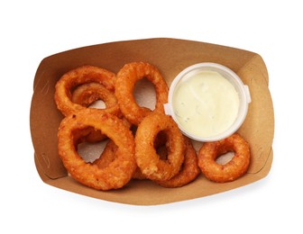 Photo of Fried squid rings and sauce in cardboard box isolated on white, top view