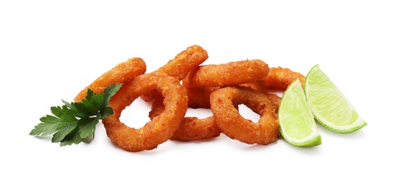Photo of Fried squid rings, lime and parsley isolated on white