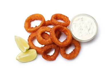 Photo of Fried squid rings, lime and sauce isolated on white, top view