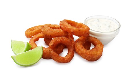 Photo of Fried squid rings, lime and sauce isolated on white
