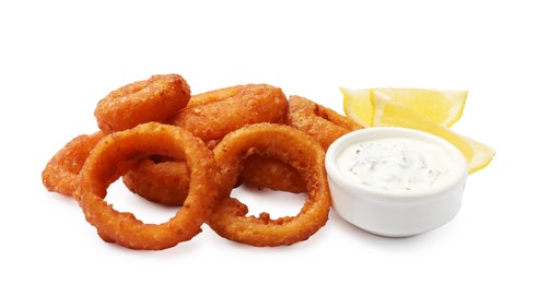 Photo of Fried squid rings, lemon and sauce isolated on white
