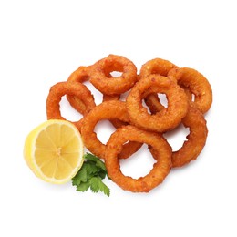 Photo of Fried squid rings, lemon and parsley isolated on white, top view